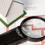 high-view-real-estate-plans-with-magnifying-glass_23-2148301767